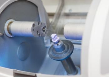 Milling machine creating a dental crown from a small ceramic block