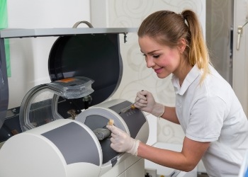Dental team member using a CEREC same day crown machine