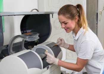 Dental team member using a CEREC same day crown machine