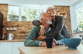 Senior man and woman sitting at their kitchen table