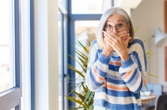 Woman covering her mouth with her hands