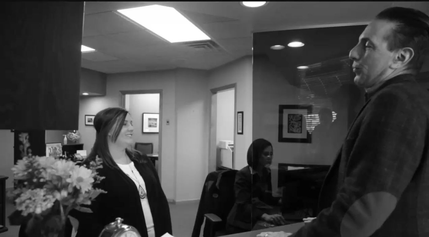 Man talking to receptionist in Gorham dental office