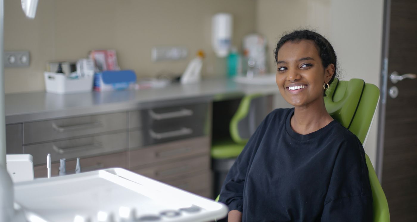 Woman smiling while sitting in dental chair