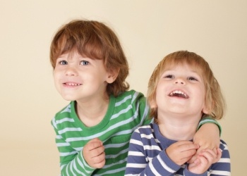 Two smiling children in striped pajamas