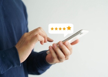 Person leaving a five star review on their phone